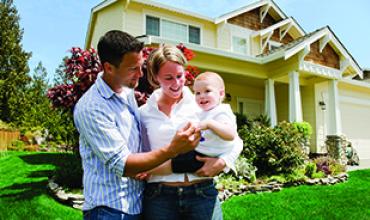 Family in front of house