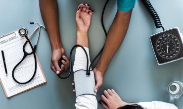 a nurse checking blood pressure