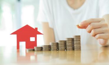Local Government Plans Can Produce Affordable Housing Outcomes an individual stacking coins
