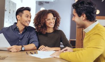 a couple sitting with a lender 