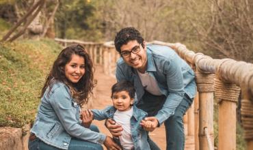New Study Shows High Housing Cost Threatens Childhood Well-Being A family posing outside
