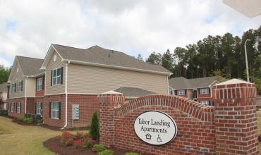 Photo of Tabor Landing sign and building in background