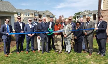 attendees cutting a ribbon at Kitkwood Crossing