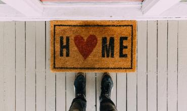 Entry mat that says "Home" on it, the "o" is a heart