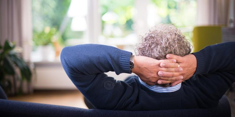 An older man relaxing on a couch