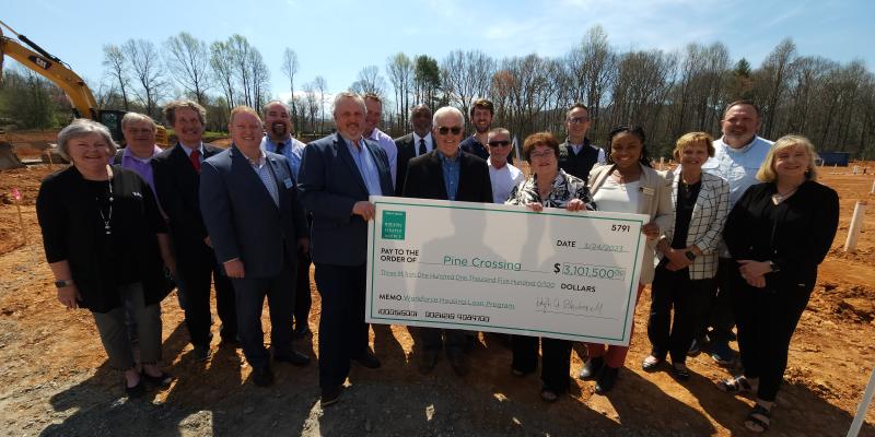 Workforce Housing Check to Be Given at Pine Crossing, Valdese, March 24 Group of people holding up a large check