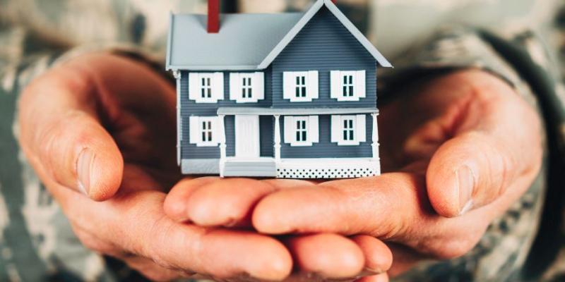 A veteran holding a house